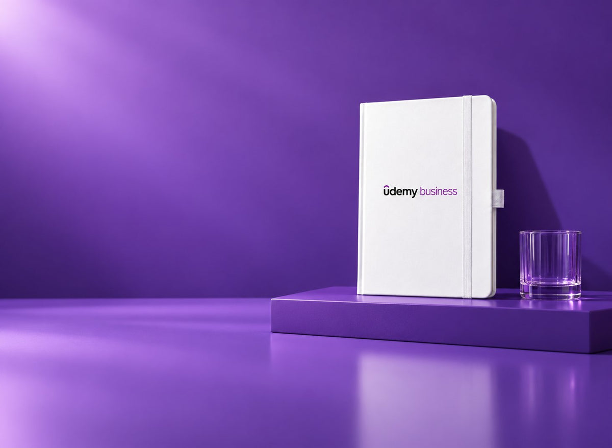 White Infinote Classic notebook with Udemy Business identity in a purple studio