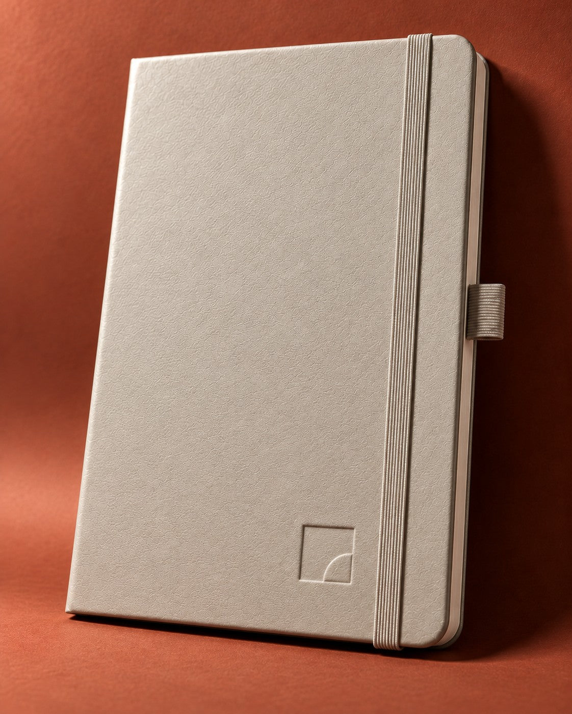 Ivory Infinote Classic notebook with a mark blind-debossed into the cover