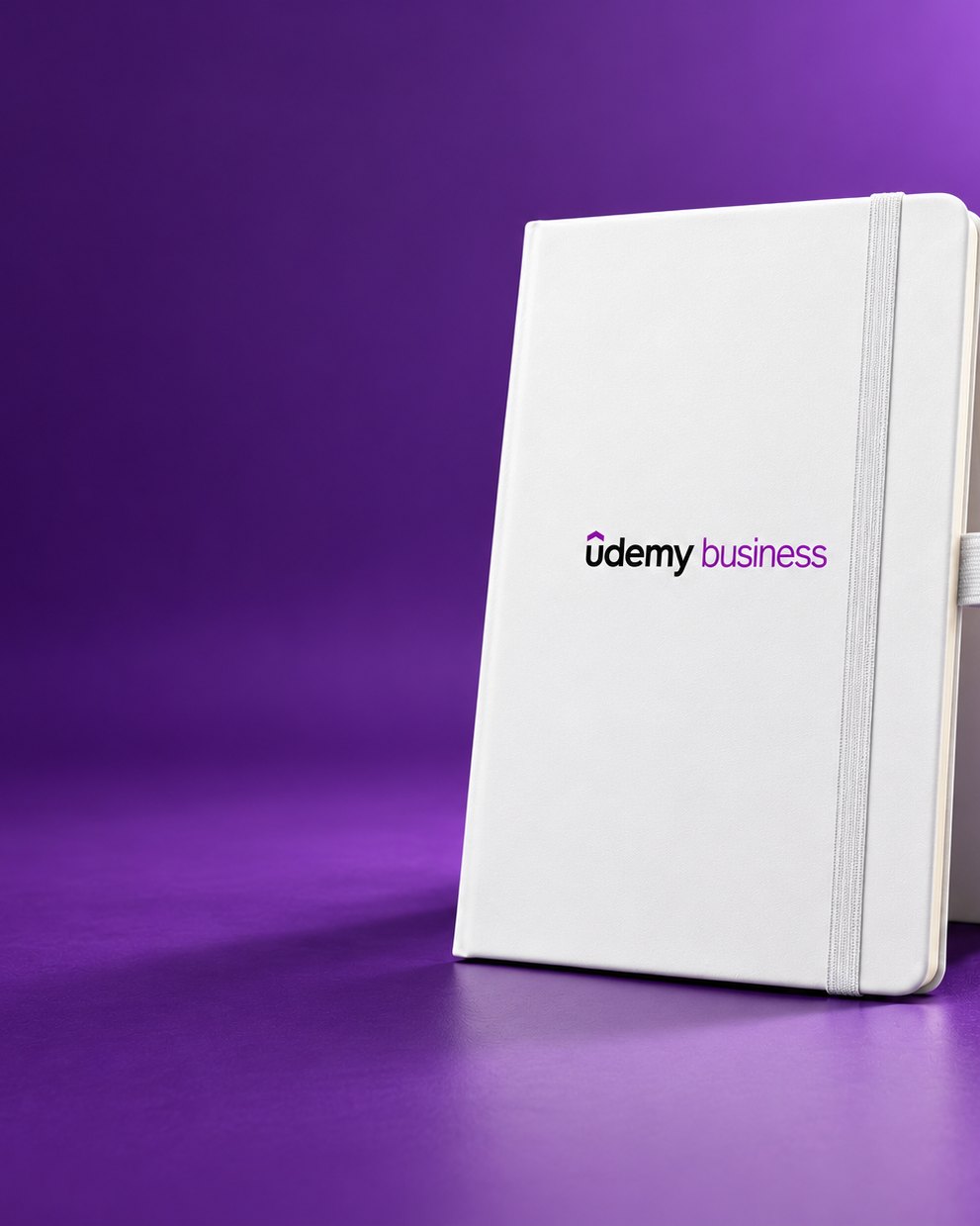 White Infinote Classic notebook with Udemy Business identity on a purple ground